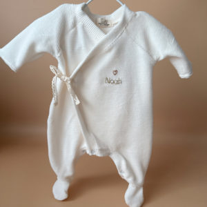 Offrez à votre nouveau-né un confort absolu avec notre pyjama de naissance écru en mini maille côtelée, soigneusement fabriqué en France. Ce pyjama allie douceur et praticité, idéal pour les premiers mois de bébé. Son design élégant en maille de velours côtelé offre une texture agréable au toucher, tandis que sa teinte écrue apporte une touche intemporelle. Il se distingue par sa personnalisation au prénom de votre enfant, en faisant un cadeau unique et inoubliable. Pratique, il est doté d'une fermeture sur le devant pour faciliter l'habillage, ainsi qu'une ouverture intégrale au niveau des pieds, rendant le changement de couches simple et rapide. Un incontournable pour le trousseau de naissance, conçu pour offrir à votre bébé le meilleur dès ses premiers jours. Un cadeau parfaitement adapté pour accueillir votre petit trésor dans le monde avec tendresse et douceur. Retrouvez dans la même gamme, nos petits chaussons de naissance ainsi que nos bonnets.