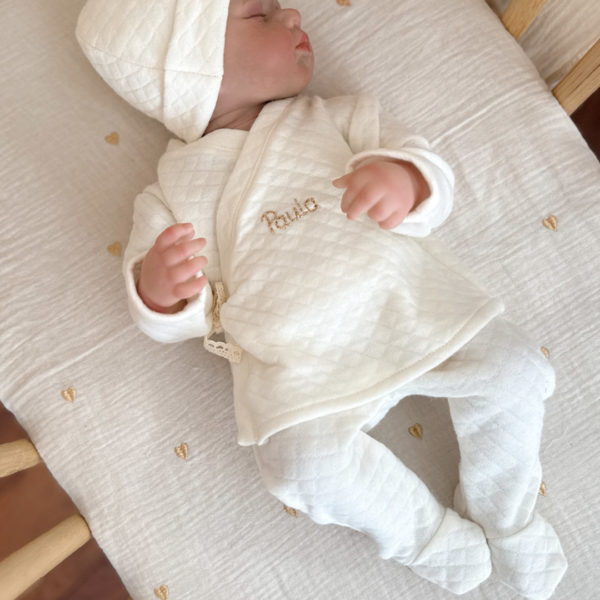 Offrez à votre bébé un premier vêtement doux, élégant et entièrement fabriqué en France avec cet adorable ensemble de naissance en coton matelassé écru. Composé d’une brassière croisée et d’un pantalon assorti, cet ensemble enveloppe bébé de confort dès ses premiers jours.